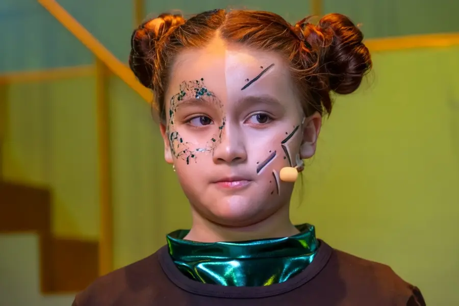 Young performer on stage in a theatre production