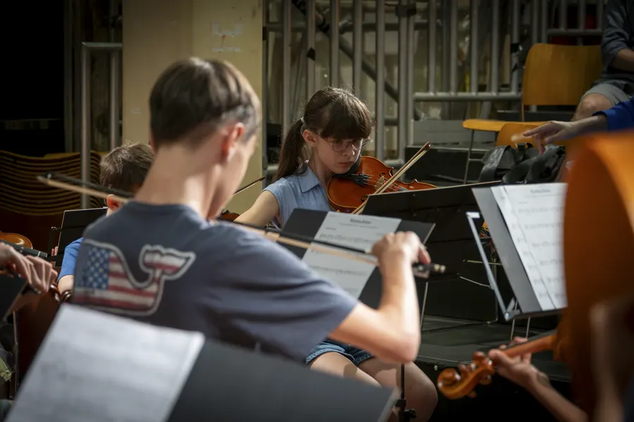 Young musicians playing together in an orchestra workshop